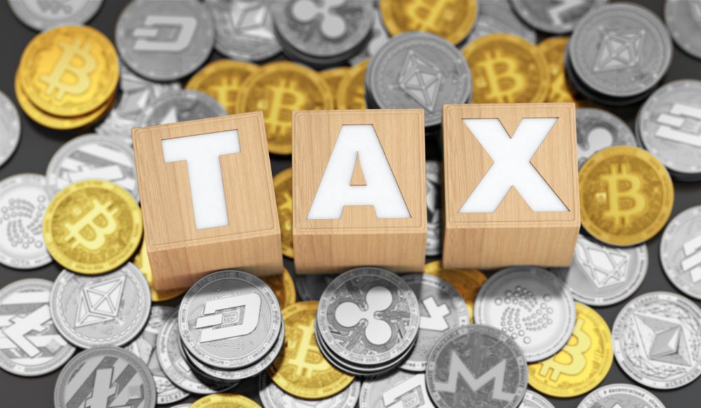 tax payments on crypto, wooden message on the background of popular cryptocurrency coins